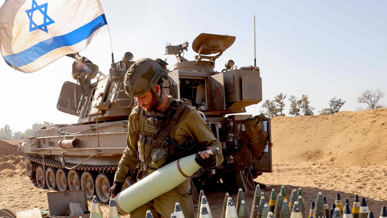 An Israeli soldier arranges artillery shells at a position near the border amid the ongoing battles between Israel and the Palestinian group Hamas in the Gaza Strip. Picture: AFP