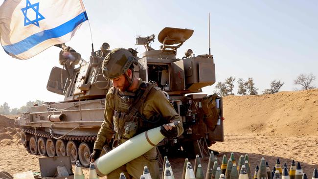 An Israeli soldier arranges artillery shells at a position near the border amid the ongoing battles between Israel and the Palestinian group Hamas in the Gaza Strip. Picture: AFP