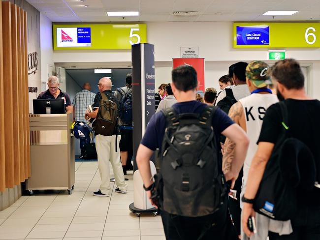 Passengers line up to board Qantas QF839 to Melbourne at Darwin International Airport.