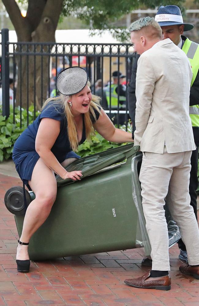 A Melbourne Cup hall of famer - this merry woman walks into an unsuspecting rubbish bin at Flemington. Picture: Scott Barbour/Getty Images