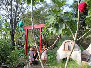 GROWING MOVEMENT: Max Burgess (centre) with her son Juno and neighbour Kahula Dangerfirld at the Little Keen St community garden.