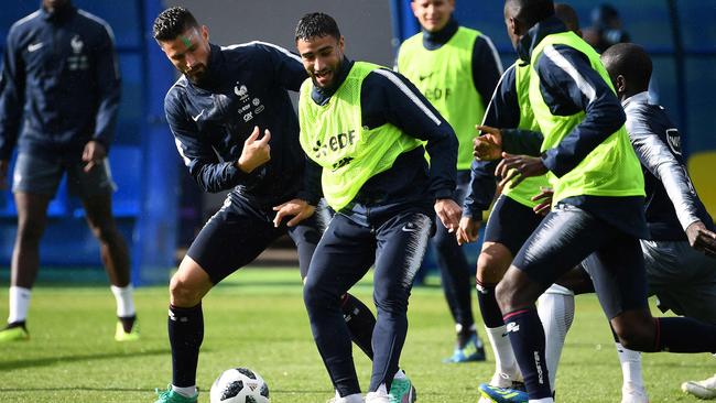 France's forward Olivier Giroud (L) vies with France's forward Nabil Fekir (C) during a training session at the Glebovets Stadium in Istra.