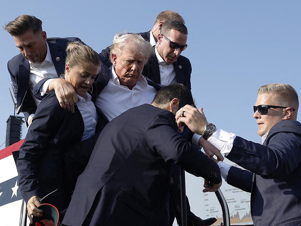 Donald Trump was rushed from the stage and into a waiting car. Picture: Getty