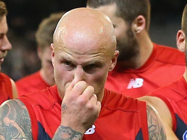 MELBOURNE, AUSTRALIA - JUNE 08: Nathan Jones, Jimmy Toumpas and Aidan Riley of the Demons look dejected after losing the round 10 AFL match between the Melbourne Demons and the Collingwood Magpies at Melbourne Cricket Ground on June 8, 2015 in Melbourne, Australia. (Photo by Quinn Rooney/Getty Images)