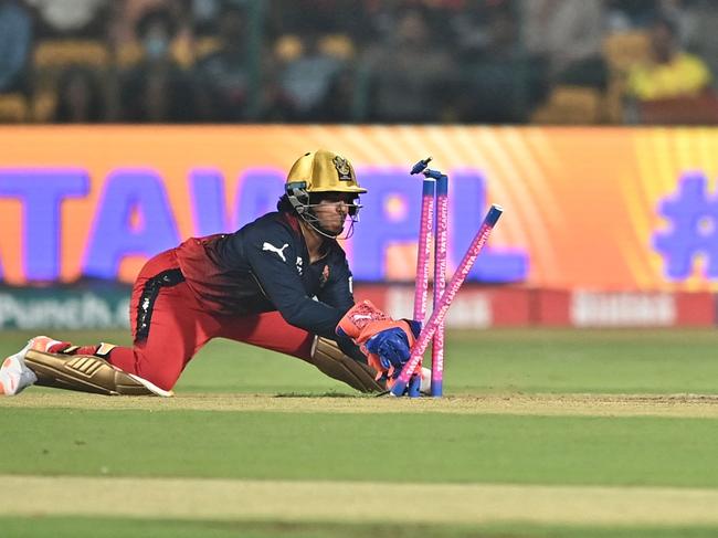 Royal Challengers Bangalore's wicket keeper Richa Ghosh (L) stumps the wicket of UP Warriorz's Kiran Navgire (R) during the Women's Premier League (WPL) Twenty20 cricket match between Royal Challengers Bangalore and UP Warriorz at the Chinnaswamy Stadium in Bengaluru on February 24, 2024. (Photo by Idrees MOHAMMED / AFP)