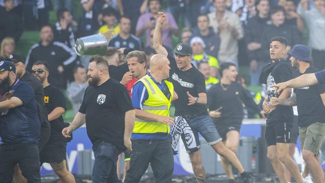 Melbourne Victory fans invade the pitch during the match between Melbourne City and the Melbourne Victory on Saturday. (AAP Image/Will Murray)