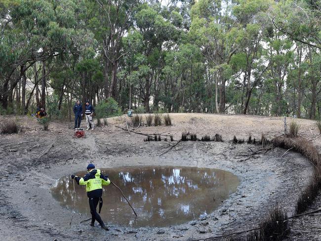 Police search and rescue officer searches for evidence in a Toolern Vale dam drained by the CFA to help with the investigation of Karen Ristevski. Picture: Nicole Garmston