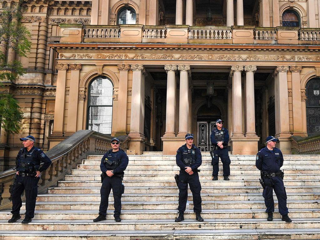 Police keep watch outside the Sydney Town Hall prior to a candlelight vigil by Pro-Palestinian Supporters on the first anniversary of the Israel-Hamas conflict, in Sydney on October 7, 2024. (Photo by Izhar KHAN / AFP)