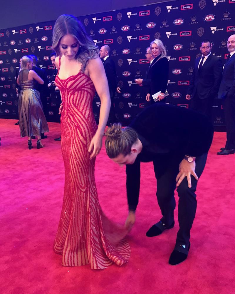 Nat Fyfe adjusts Elli Brashaw's dress.