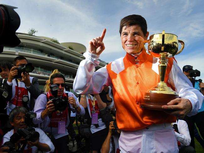 Jockey Craig Williams (right) holds the Melbourne Cup Trophy after riding Vow And Declare to victory in race 7, the Lexus Melbourne Cup during Melbourne Cup Day, at Flemington Racecourse in Melbourne, Tuesday, November 5, 2019. (AAP Image/James Ross) NO ARCHIVING, EDITORIAL USE ONLY