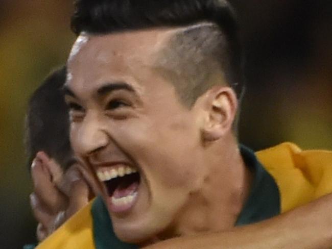 Jason Davidson of Australia (C) celebrates scoring the second goal against United Arab Emirates in their AFC Asian Cup semi-final football match in Newcastle on January 27, 2015. AFP PHOTO/Peter PARKS --IMAGE RESTRICTED TO EDITORIAL USE - STRICTLY NO COMMERCIAL USE