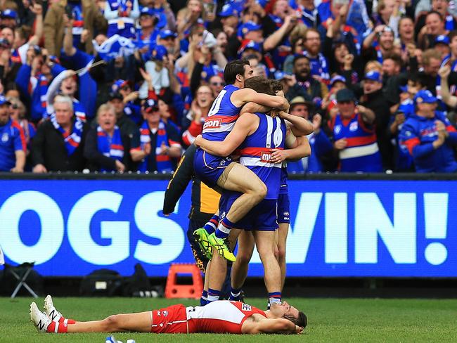 Western Bulldogs players and fans celebrate on the final siren. Picture: Toby Zerna