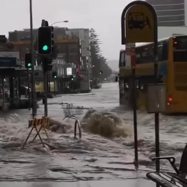 Flooding, coming from a stormwater drain, across Pittwater Rd in the Dee Why CBD on Thursday morning. Picture: SES