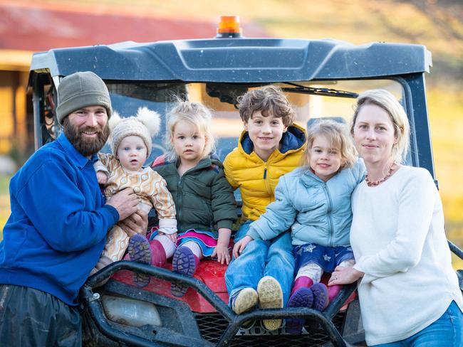 BOWNA, AUSTRALIA - The Australian. 13 July 2022 : Freelance writer Virginia Tapscott from Bowna near Albury. Virginia has written a very personal piece about her decision to be a stay at home mum, and how she feels she is undervalued for the work she puts in. Pictured with her family Tully 8mths, Oscar 6yrs, Elke 4yrs, Eva 2yrs and husband Rhys.Photo by - Simon Dallinger