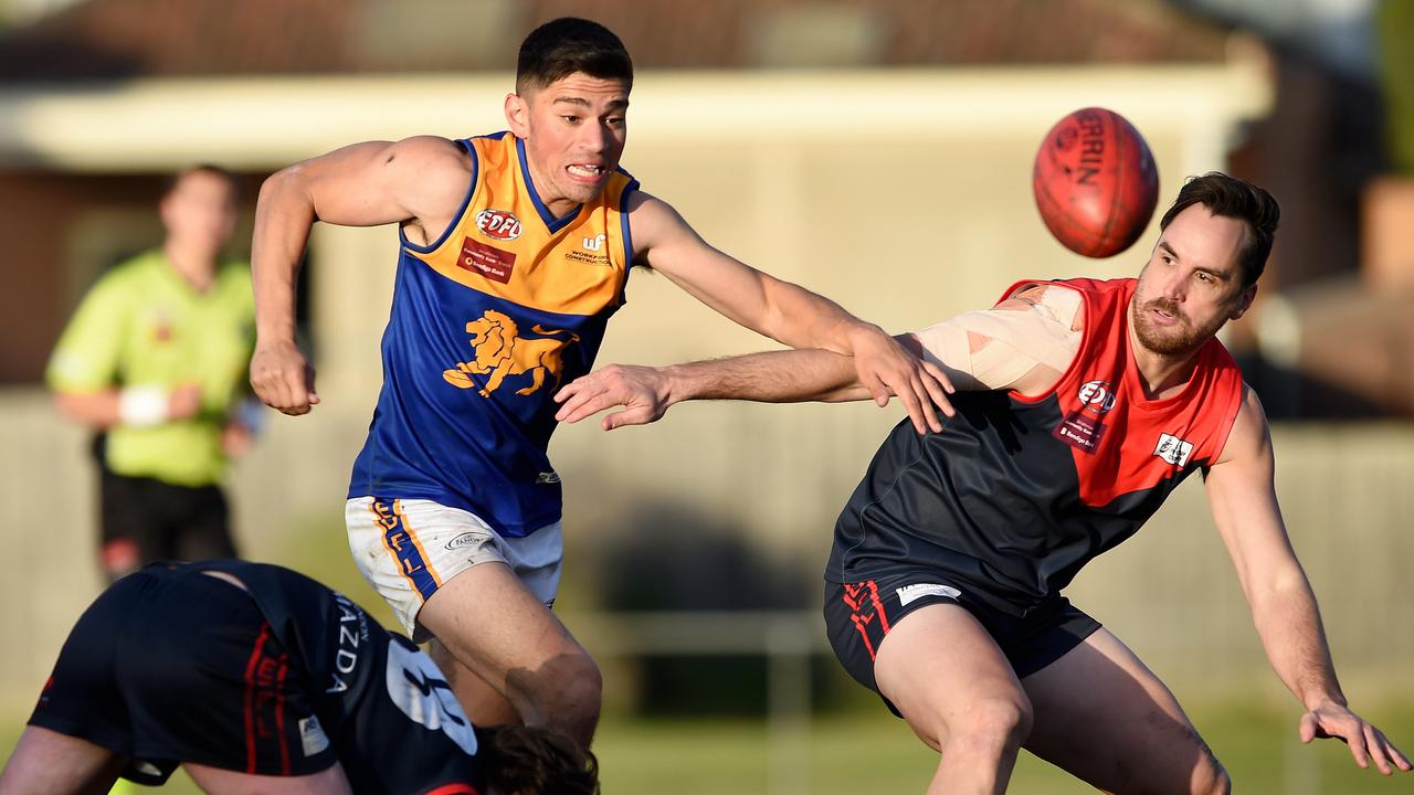 Essendon District: Taylor’s Lakes’ Kerim Hasan has eyes for the ball against Adam Bartrop of Tullamarine. Picture: Steve Tanner