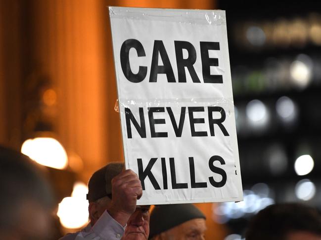 Pro life demonstrators are seen outside the Victorian State Parliament, Melbourne, Tuesday, June 18, 2019. The protest has been called to oppose the voluntary assisted dying laws coming into effect from Wednesday. (AAP Image/James Ross) NO ARCHIVING