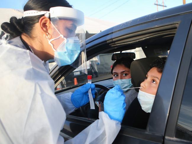 EL PASO, TEXAS - NOVEMBER 13: Frontline healthcare worker Joanne Grajeda administers a nasal swab test at a drive-in COVID-19 testing site amid a surge of COVID-19 cases in El Paso on November 13, 2020 in El Paso, Texas. Texas eclipsed one million COVID-19 cases November 11th with El Paso holding the most cases statewide. Health officials in El Paso today announced 16 additional COVID-19 related deaths along with 1,488 new cases pushing the virus death toll to 741. Active cases in El Paso are now over 30,000.   Mario Tama/Getty Images/AFP == FOR NEWSPAPERS, INTERNET, TELCOS & TELEVISION USE ONLY ==