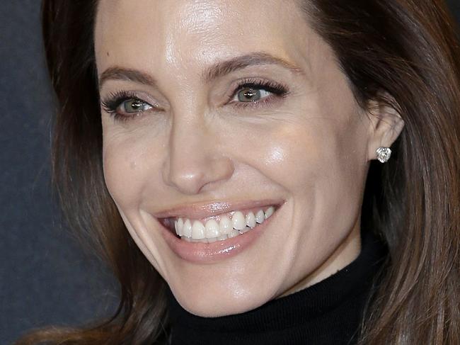 FILE - In this Nov. 27, 2014 file photo, director Angelina Jolie poses for photographers during a photo call for her film "Unbroken" in Berlin, Germany. The film did not receive any Golden Globe nominations on Thursday. (AP Photo/Michael Sohn, File)