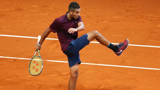 Nick Kyrgios kicks the ball during his loss to Kei Nishikori at the Madrid Open.