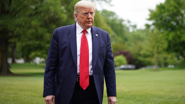 President Trump walks across the South Lawn upon return to the White House in Washington on Sunday. Picture: AFP