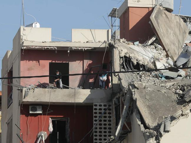 Emergency responders inspect the debris at the site of an Israeli airstrike that targeted a building in the Haret Saida area, next to southern Lebanese city of Sidon. Picture: AFP