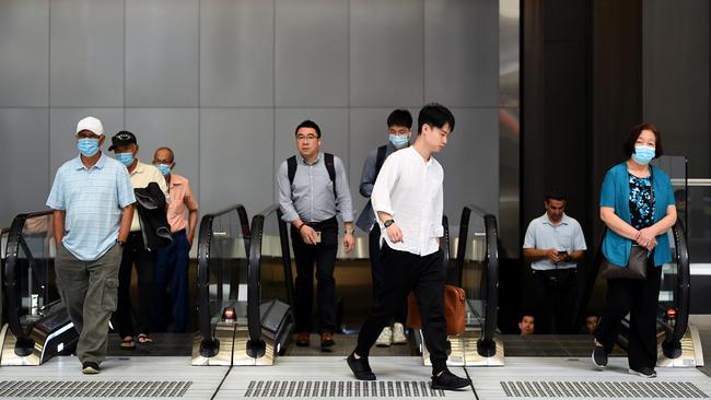 Workers commute through the central business district in Sydney, New South Wales. Picture: NCA NewsWire/Joel Carrett