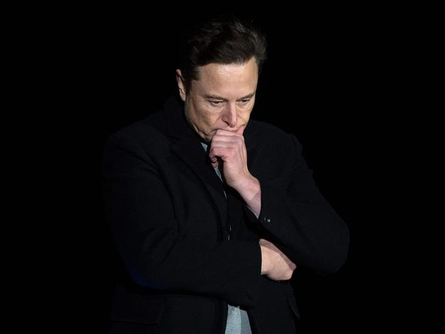 Elon Musk pauses and looks down as he speaks during a press conference at SpaceX's Starbase facility near Boca Chica Village in South Texas on February 10, 2022. - Billionaire entrepreneur Elon Musk delivered an eagerly-awaited update on SpaceX's Starship, a prototype rocket the company is developing for crewed interplanetary exploration. (Photo by JIM WATSON / AFP)