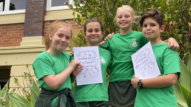 Ipswich North State School Year 5 students and EcoMarines ambassadors Rebecca Meale, Sophie Gardner, Faith Hardaker, and Nathaniel Carey and their ‘Colouring for a Cause’ book. Picture: Jessica Baker