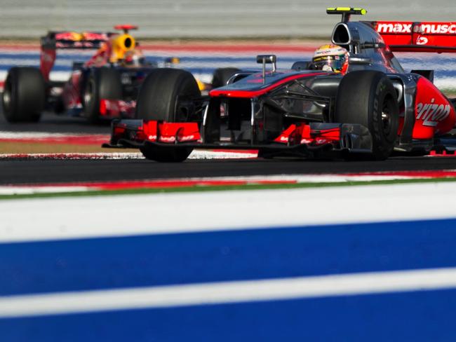 Lewis Hamilton (right) is followed by driver Sebastian Vettel (left) during the 2012 US Formula 1 Grand Prix, attended by Petroecuador officials. Picture: Jim Watson/AFP.