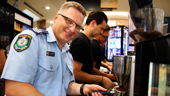 Sargent Paul Lock makes coffee at the Franky &amp; Co coffee shop. (AAP Image / Angelo Velardo)