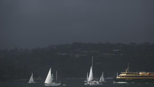 Thunderstorms make their way south east over Sydney harbour along with a thick fog blanketing the city. Photo: Tim Pascoe