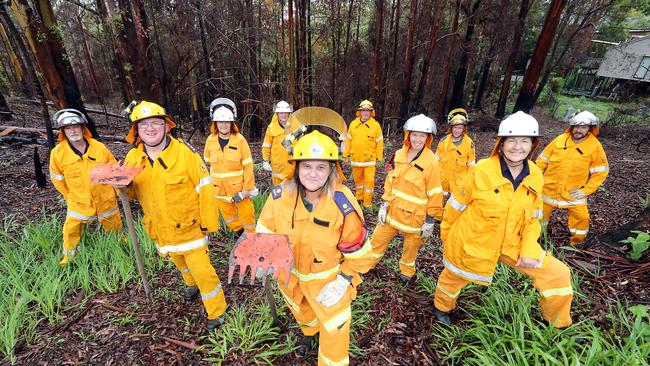 Kim Crow (centre) with fellow Lower Beechmont Rural Fire Brigade members. (L-R) are Jim Bush, Darryl Hall, Carol Bowhay, Ian Gilbert, Phil Rankin, Angela Ritchie, Dean Cording, Britt Mortensen, Rex Adams. Picture: Richard Gosling