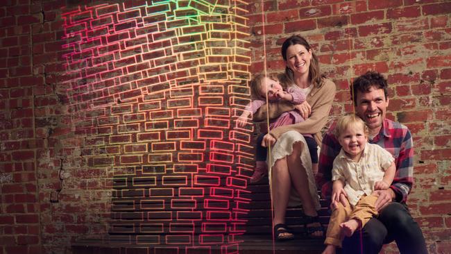 Gwyll Jahn is wife Rosemary Gunzburg and twins Kip and Elsie, nearly two. Visible is virtual brick overlay down the side of the family’s current home, which will be replaced by a new home built using augmented reality software pending council’s approval of the plans Picture: Eugene Hyland