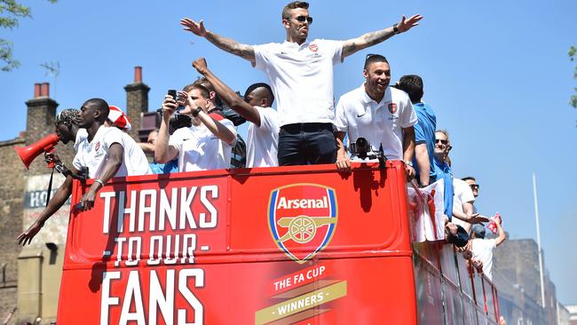 Arsenal's English midfielder Jack Wilshere leads celebrations.