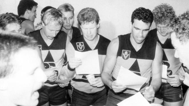 Brisbane Bears Players (from left) Waterson, Richardson, Brad Hardie, Mark Williams and Fidge ready the lyrics to their theme song after their first win.