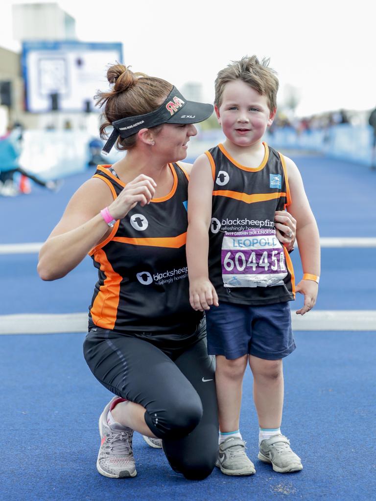 Thanks Mum. Leo Kohlmorgan, 5, is congratulated by Mum Alexia from Adelaide at the finish of the Two Kilometre Junior Dash. Picture: Tim Marsden.