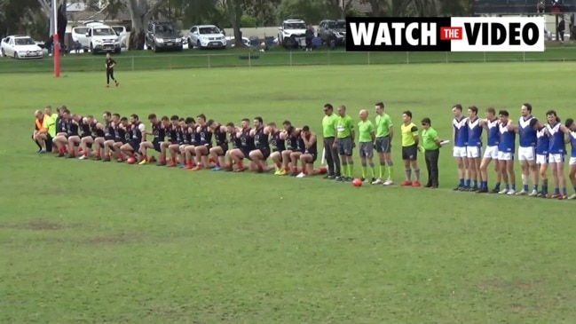 Pooraka players take a knee during anthem