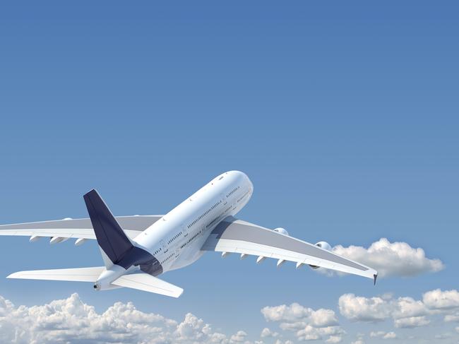 airplane in the sky seen from behind with copy space in the top and a clipping path in the plane