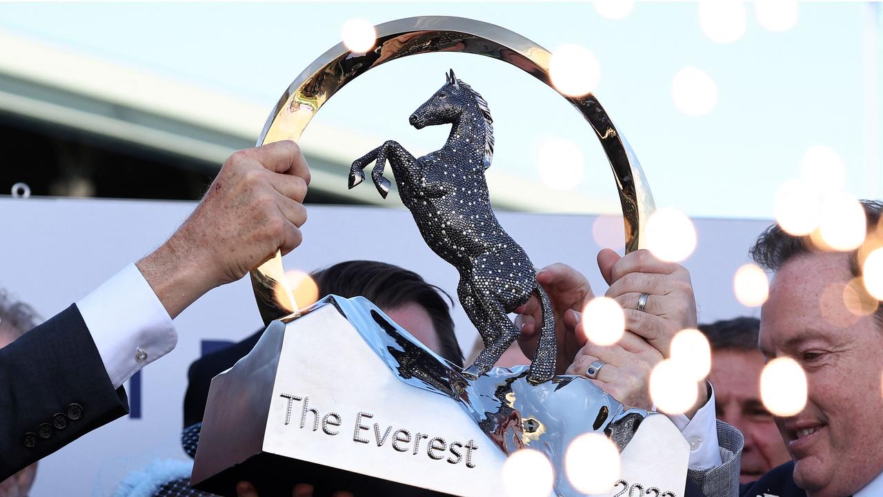 Team members of Australian sprinter, Think About It, lift the winning trophy after the world's richest turf race, The Everest, in Sydney on October 14, 2023. The Joe Pride-trained five-year-old stormed through the field in the final 100 metres at Royal Randwick to collect a whopping Aus$7.0 million (US$4.4 million) for barely a one-minute dash. (Photo by DAVID GRAY / AFP) / -- IMAGE RESTRICTED TO EDITORIAL USE - STRICTLY NO COMMERCIAL USE --