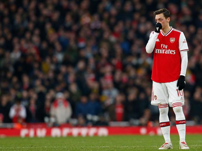 Arsenal's German midfielder Mesut Ozil reacts during the English Premier League football match between Arsenal and Chelsea at the Emirates Stadium in London on December 29, 2019. (Photo by Ian KINGTON / IKIMAGES / AFP) / RESTRICTED TO EDITORIAL USE. No use with unauthorized audio, video, data, fixture lists, club/league logos or 'live' services. Online in-match use limited to 45 images, no video emulation. No use in betting, games or single club/league/player publications.