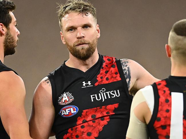 MELBOURNE, AUSTRALIA - JULY 03: Jake Stringer of the Bombers is congratulated by team mates after kicking a goal during the round 5 AFL match between the Collingwood Magpies and he Essendon Bombers at Melbourne Cricket Ground on July 03, 2020 in Melbourne, Australia. (Photo by Quinn Rooney/Getty Images)