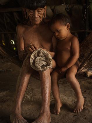 A child watches as an elder of the tribe knits a hat in the traditional fashion. Picture: Pete Oxford/ mediadrumworld.com