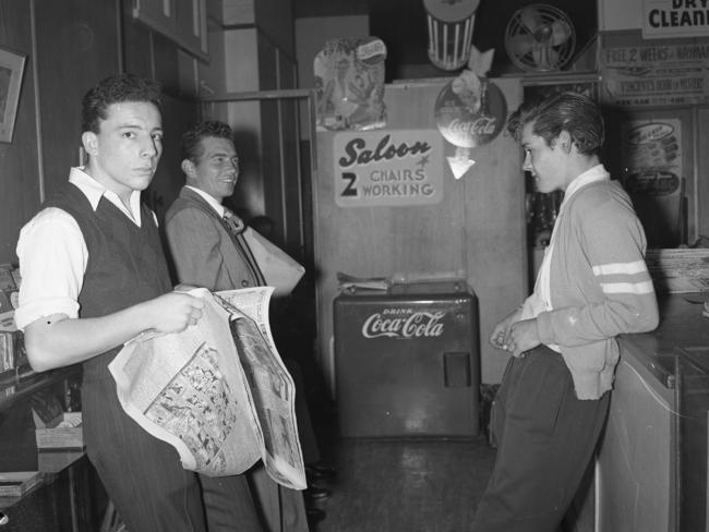 A 1955 barber’s shop in Brisbane. Here three young men wait to have their bodgie-style haircut. A bodgie was similar to greaser culture in the US and bodgies were well-known for their often loutish behaviour.