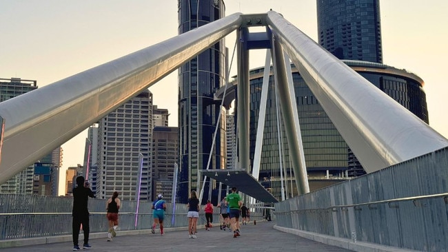 Some of the first people to cross the Neville Bonner Bridge following its opening to the public. Picture: Mikaela Mulveney