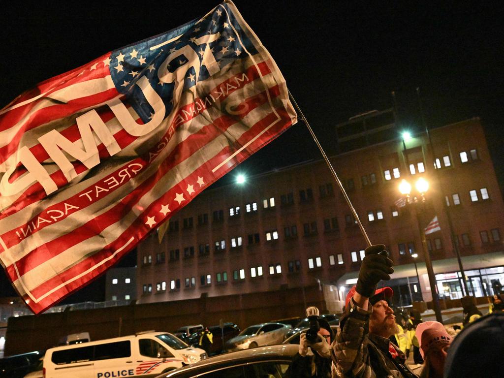 A supporter of imprisoned participants of the January 6, 2021 riot on the US Capitol, waves a Trump flag outside the DC Central Detention Facility in Washington, DC, on January 20, 2025. Picture: Roberto Schmidt/AFP