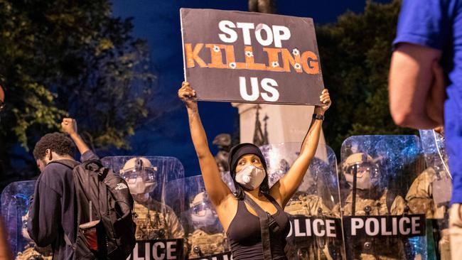 A demonstrator faces off with a police line outside the White House. Picture: AFP