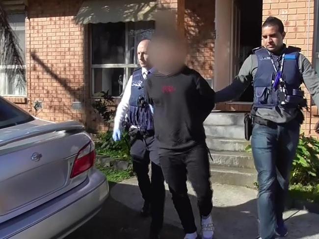 Detectives arrest a man after finding firearms and drugs in Oakleigh East on Tuesday. Picture: Police Media