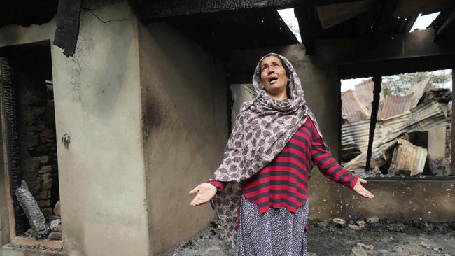 Rubina Begum wails as she stands outside her house damaged by Pakistani artillery shelling at Salamabad village in Indian-controlled Kashmir on Thursday. Picture: AP Photo/Mukhtar Khan