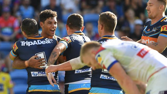 Brian Kelly of the Titans (left) reacts after scoring a try during the Round 6 NRL match between the Gold Coast Titans and the Newcastle Knights at CBUS Stadium on the Gold Coast, Sunday, April 21, 2019. (AAP Image/Dave Hunt) NO ARCHIVING, EDITORIAL USE ONLY