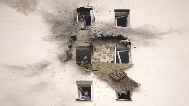 Investigators look at the damage of an apartment building where the downed Ukrainian drone fell in Sapronovo village outside Moscow. Picture: AP